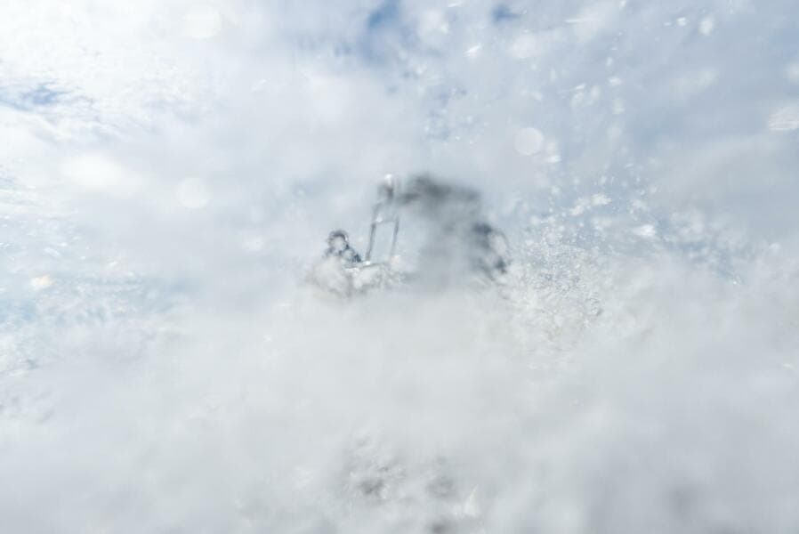 2025 BlueZones Boatworks 16' Flats navigating through splashing water.