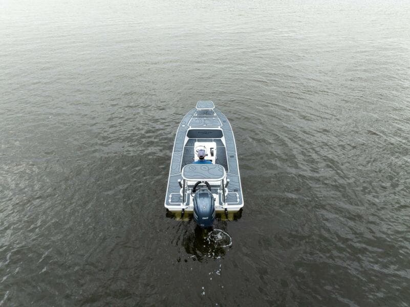 2025 BlueZones Boatworks 16' Flats boat on calm water, aerial view.