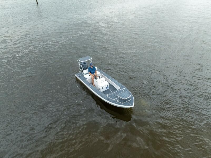 2025 BlueZones Boatworks 16' Flats boat on calm water, aerial view.