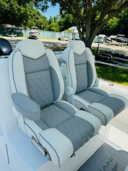 2022 Invincible 36 Open Fisherman boat seats, gray and white leather, outdoor setting.