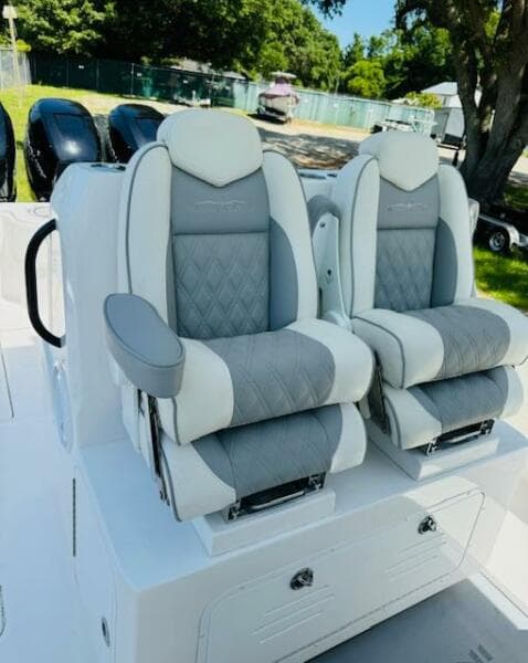 2022 Invincible 36 Open Fisherman boat seats, gray and white upholstery, outdoor setting.
