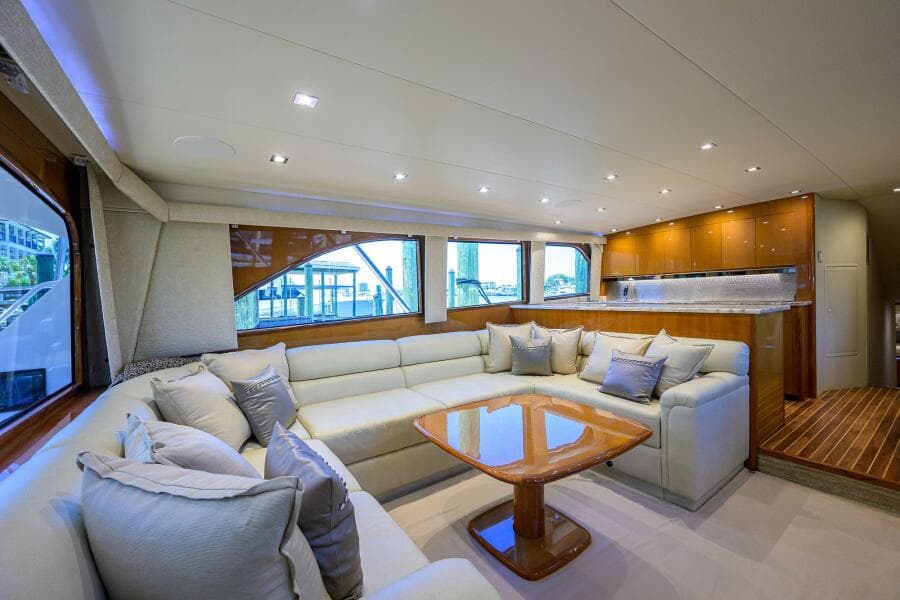 Luxurious interior of 2004 Viking 65 Enclosed Bridge yacht with spacious seating and modern kitchen.