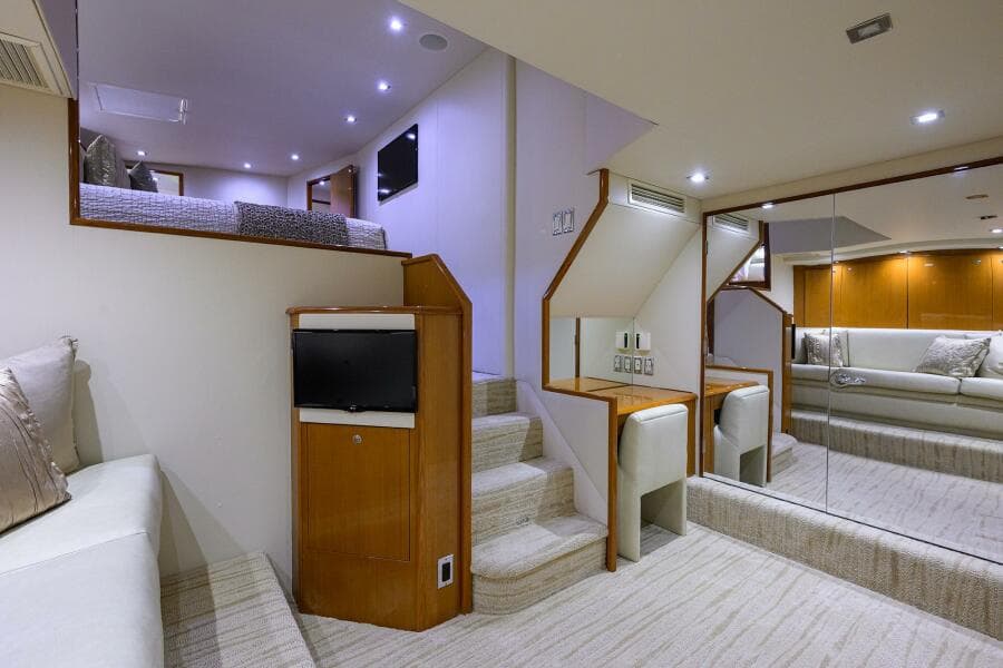 Interior of 2004 Viking 65 Enclosed Bridge yacht with modern seating and stairs.