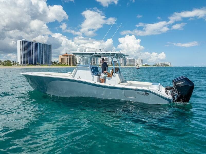 2025 Billfish 39 Center Console boat on clear blue water near city skyline.