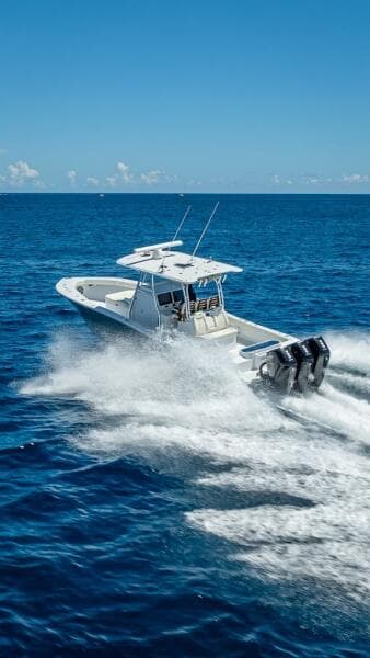 2025 Billfish 39 Center Console boat speeding on open ocean.