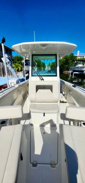 2021 Sailfish 272 CC boat interior with seating and console, docked under clear blue sky.