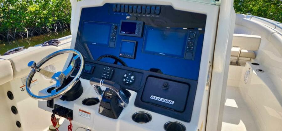 2021 Sailfish 272 CC boat dashboard with navigation controls and steering wheel.