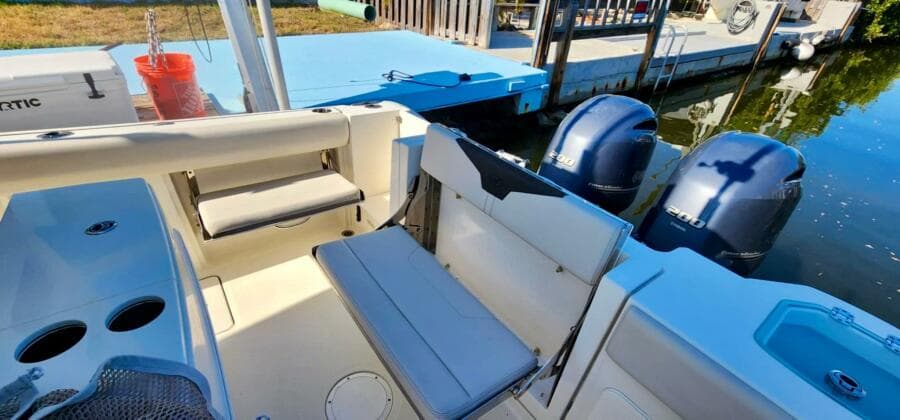 2021 Sailfish 272 CC boat interior with seating and dual outboard motors.