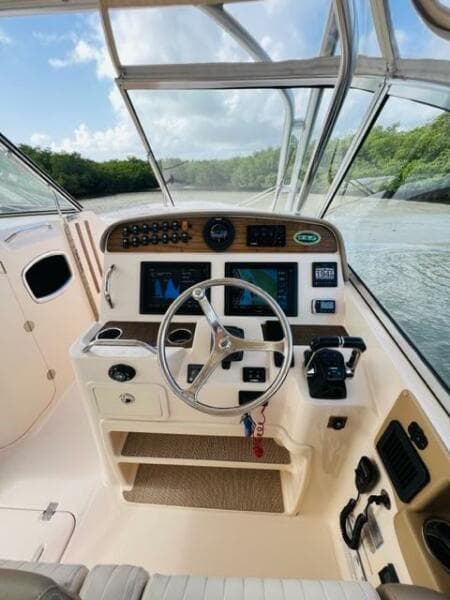 2014 Grady-White Freedom 335 boat cockpit with steering wheel and navigation controls.
