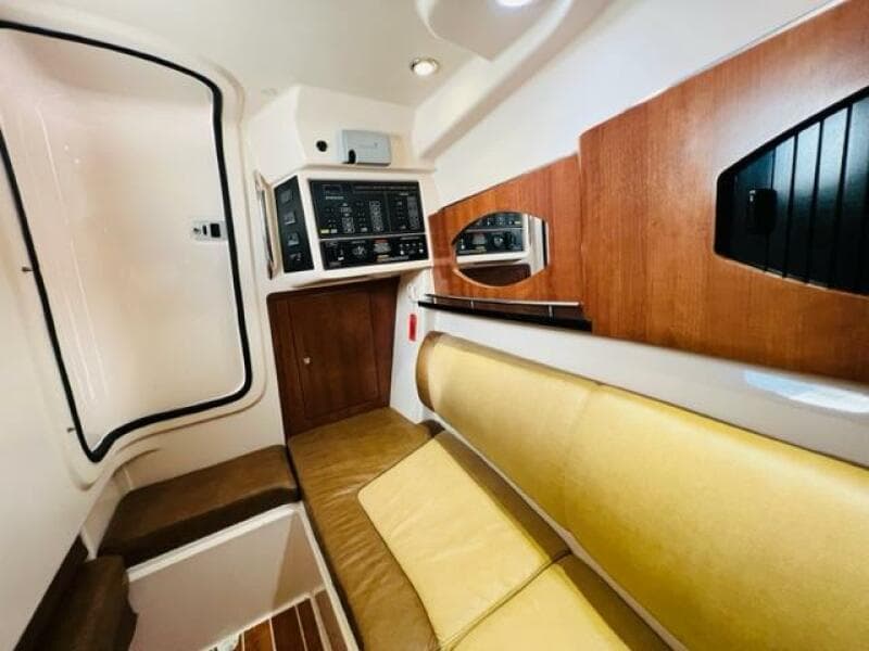 Interior cabin of a 2014 Grady-White Freedom 335 boat with control panel and seating.
