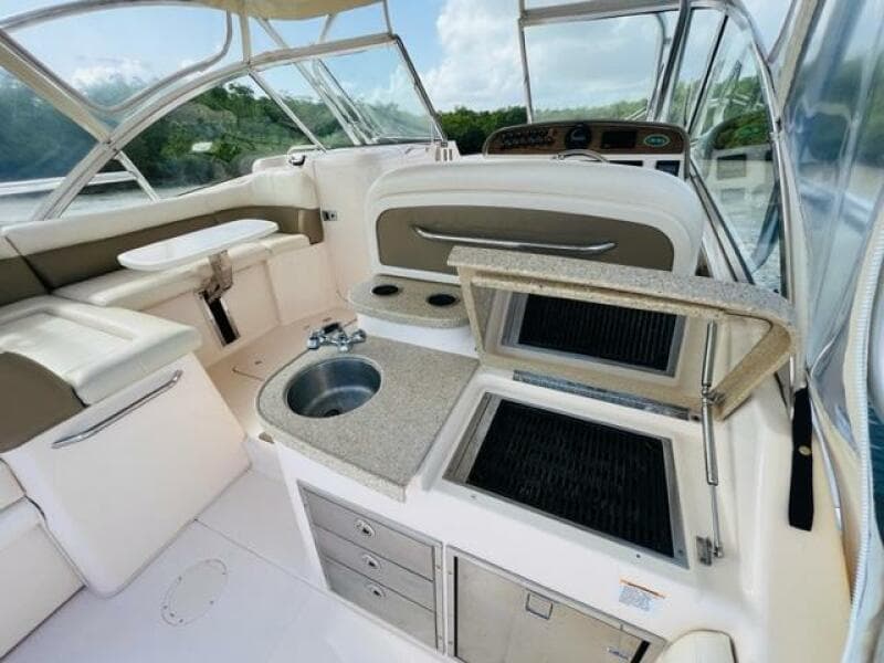 2014 Grady-White Freedom 335 boat interior with kitchenette and seating area.
