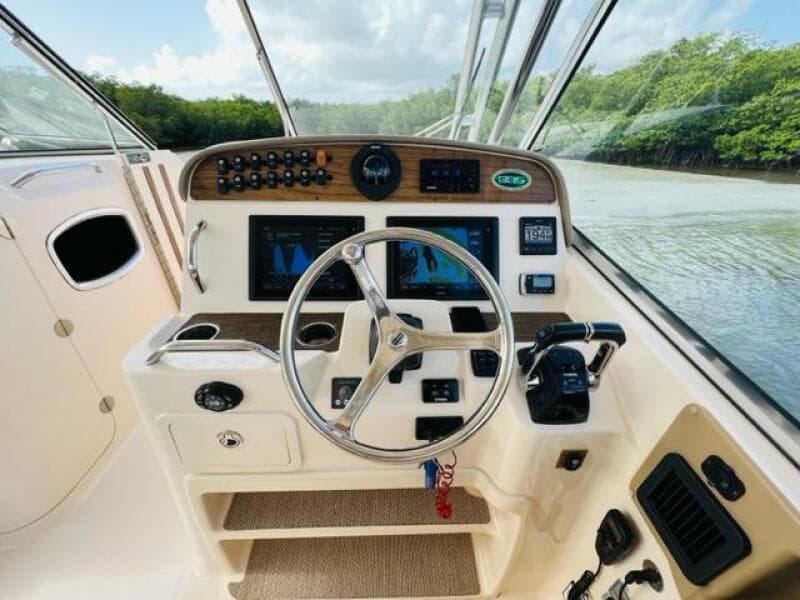 2014 Grady-White Freedom 335 boat helm with steering wheel and navigation controls.