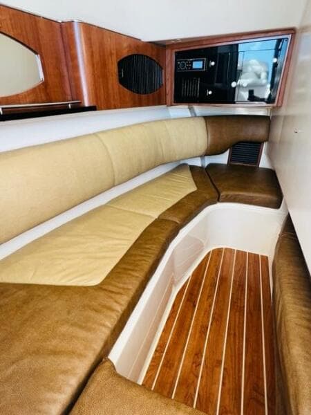 2014 Grady-White Freedom 335 cabin interior with cushioned seating and wooden flooring.