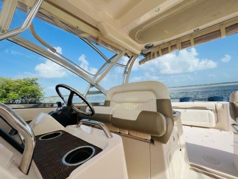 2014 Grady-White Freedom 335 boat interior with steering wheel and seating, ocean view.