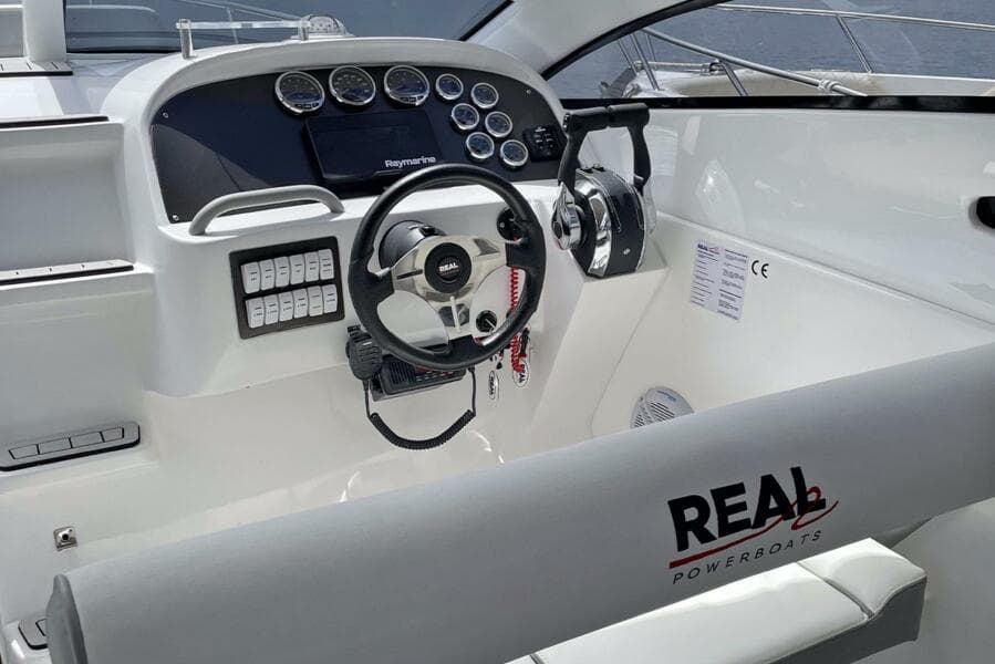 Real 35 Special Deck (SD) 2023 boat cockpit with steering wheel and control panel.