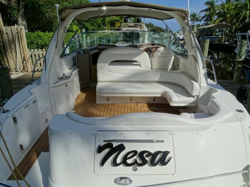 2001 Sea Ray 410 Sundancer yacht with white seating and wooden deck.