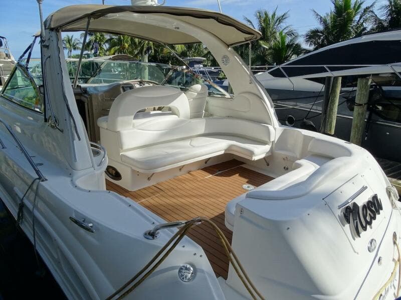 2001 Sea Ray 410 Sundancer yacht with spacious seating and teak deck, docked at marina.
