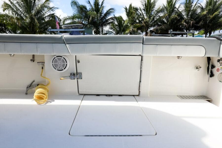2020 Regulator 41 boat deck with storage compartments and coiled hose.