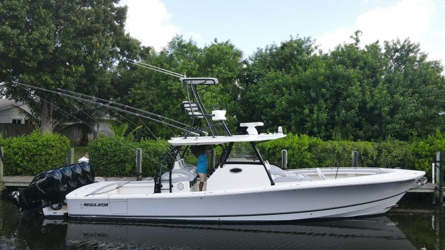 2020 Regulator 41 boat docked near lush greenery.