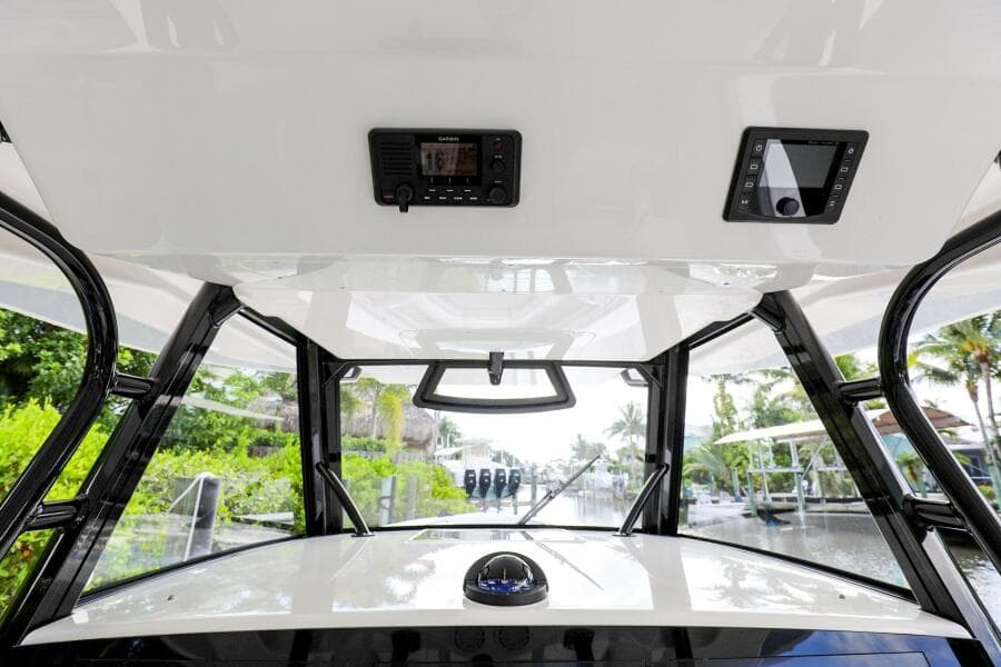2020 Regulator 41 boat helm station with electronics and overhead console.