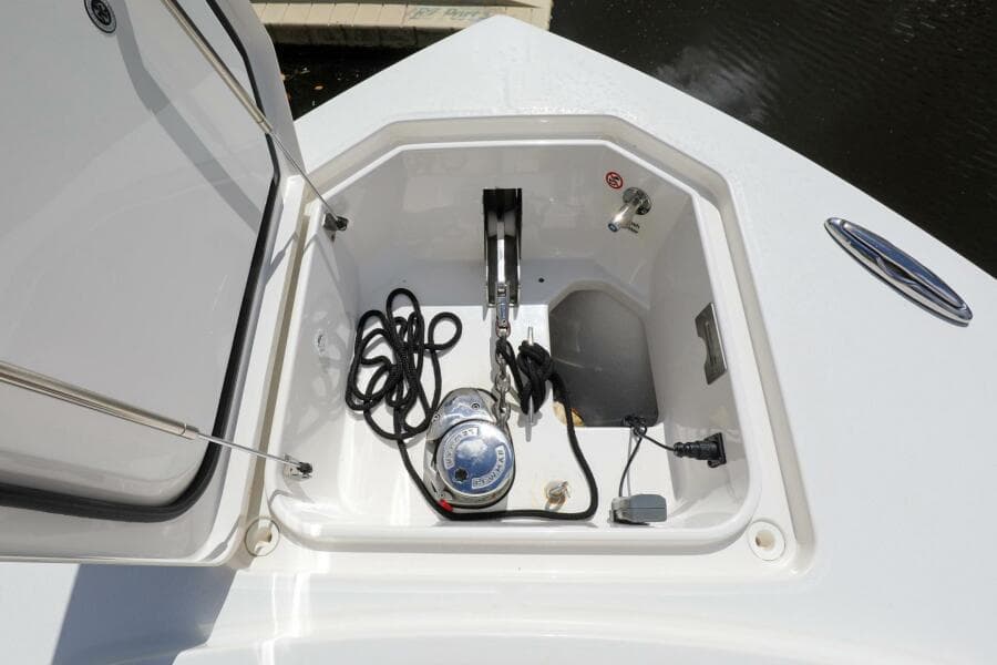 Open storage compartment on a 2020 Regulator 41 boat with anchor and ropes.