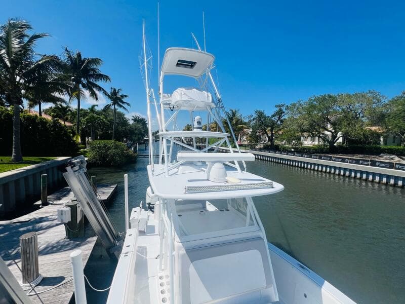 2015 Billfish 39 Custom CC boat docked in a sunny canal.