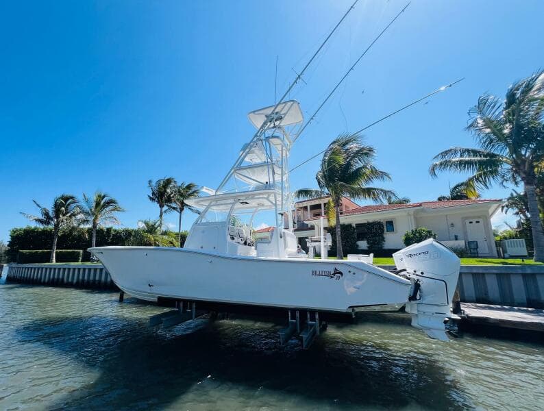 2015 Billfish 39 Custom CC boat docked near waterfront homes.