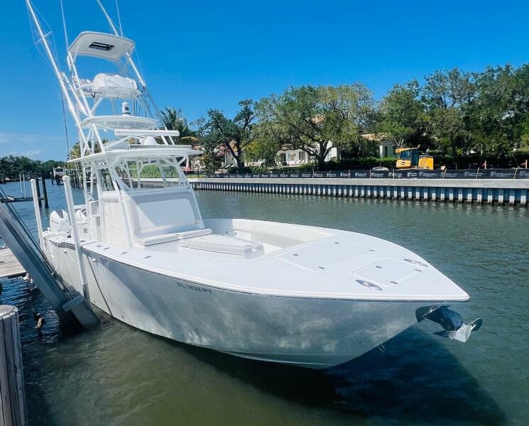 2015 Billfish 39 Custom CC boat docked by a riverside.