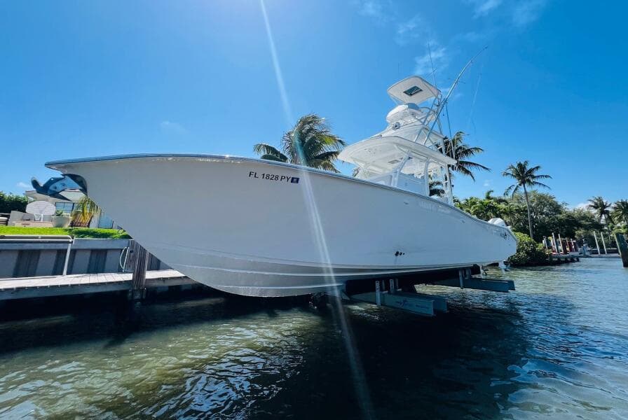 2015 Billfish 39 Custom CC boat docked by the water on a sunny day.