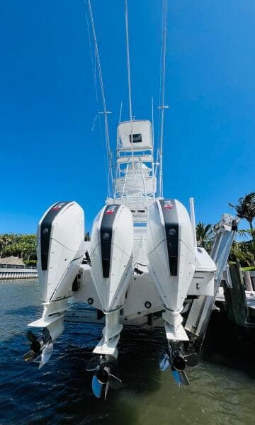 2015 Billfish 39 Custom CC boat with triple outboard engines docked.
