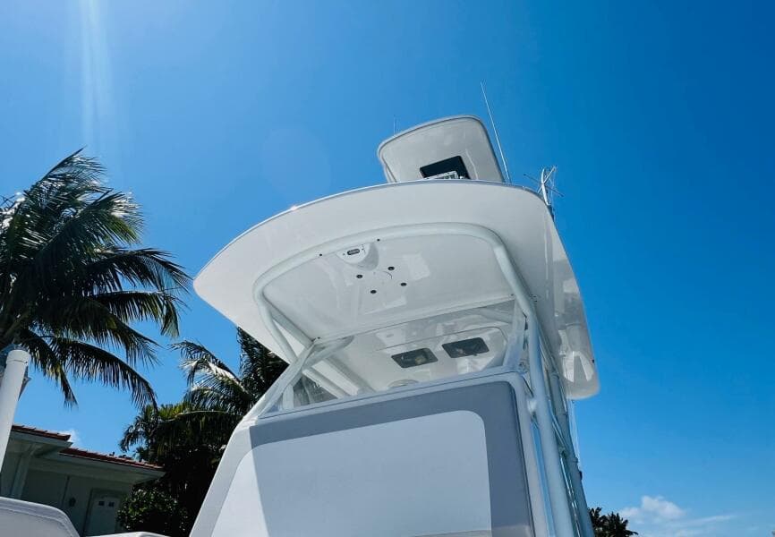 2015 Billfish 39 Custom CC boat under clear blue sky with palm trees.
