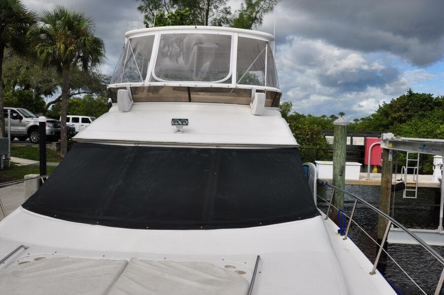 1998 Sea Ray 480 Sedan Bridge yacht docked at marina.