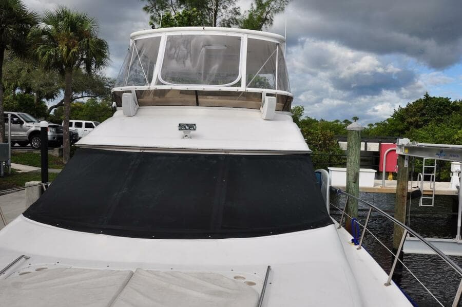 1998 Sea Ray 480 Sedan Bridge yacht docked at a marina.
