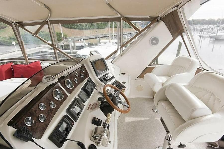 1998 Sea Ray 480 Sedan Bridge helm with leather seats and advanced navigation controls.