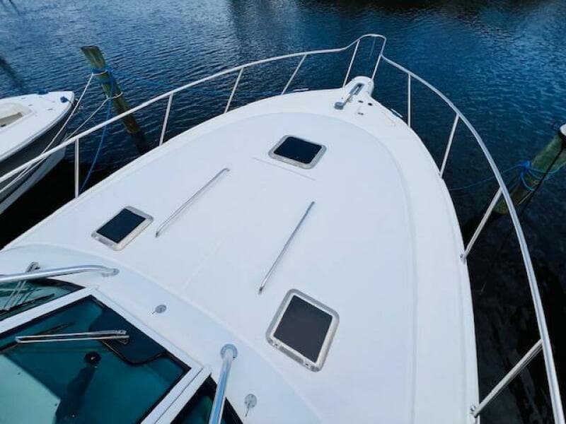 Tiara Yachts 3800 Open 2003 model, white deck view, docked on calm water.
