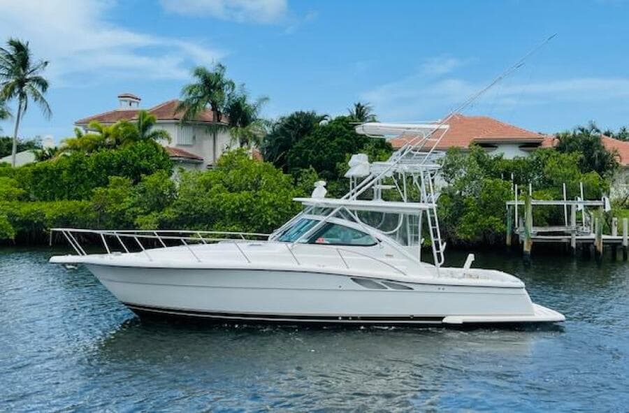 2003 Tiara Yachts 3800 Open cruising on a scenic waterway with lush greenery.