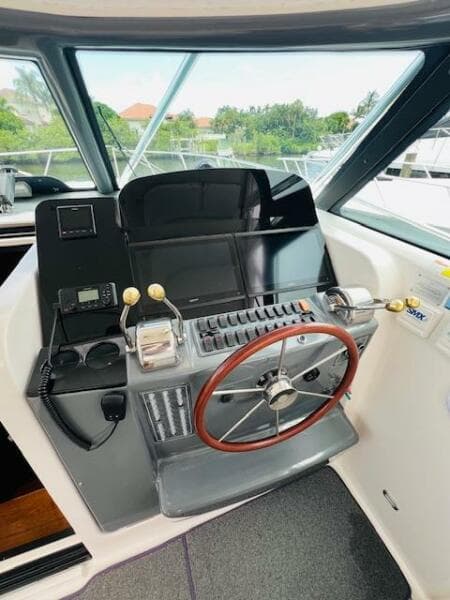 2003 Tiara Yachts 3800 Open helm with steering wheel and control panel.