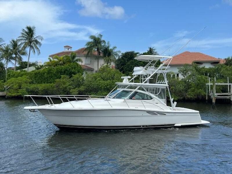 2003 Tiara Yachts 3800 Open cruising on a scenic waterway with lush greenery.