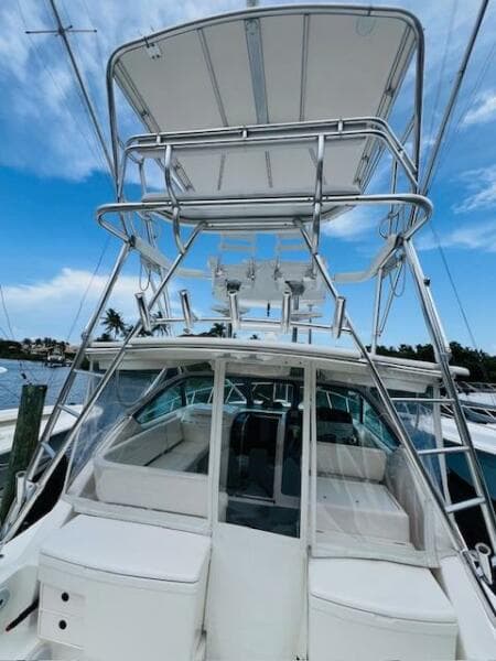2003 Tiara Yachts 3800 Open with tower, docked under blue sky.