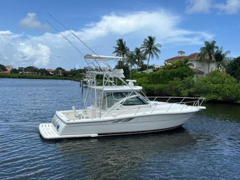 2003 Tiara Yachts 3800 Open on a scenic waterway with palm trees.