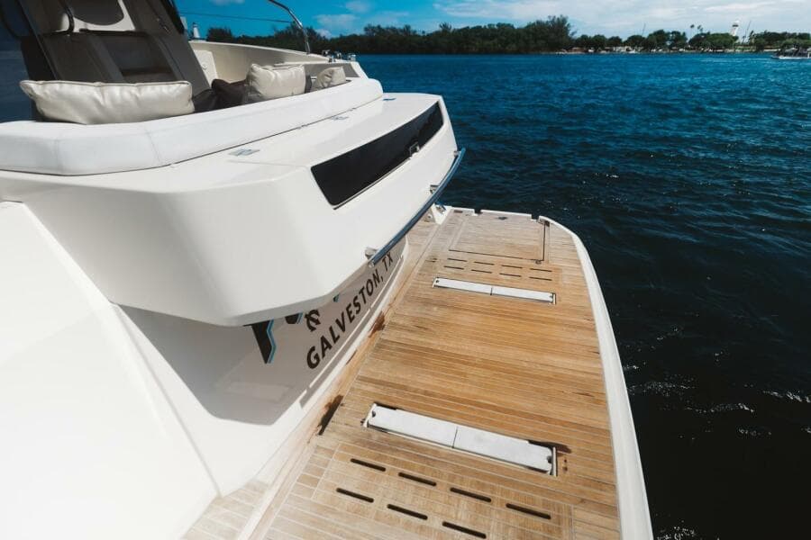 2015 Beneteau Monte Carlo 5 yacht with teak swim platform on calm water.