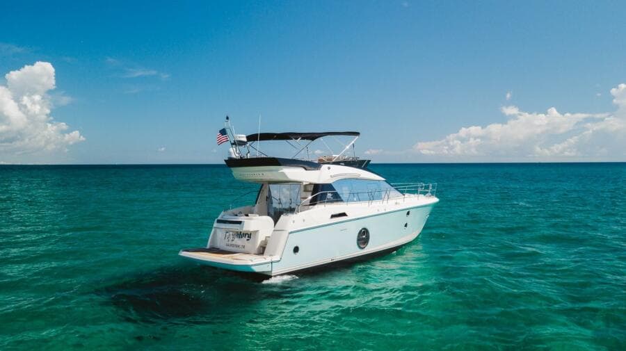 2015 Beneteau Monte Carlo 5 yacht cruising on clear blue ocean waters.