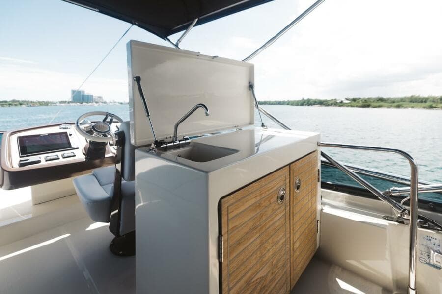 Beneteau Monte Carlo 5 yacht kitchen area with sink, 2015 model, overlooking water.