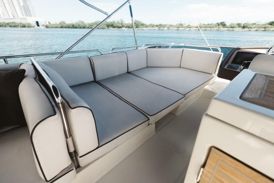 Luxurious seating on 2015 Beneteau Monte Carlo 5 yacht, overlooking serene waters.
