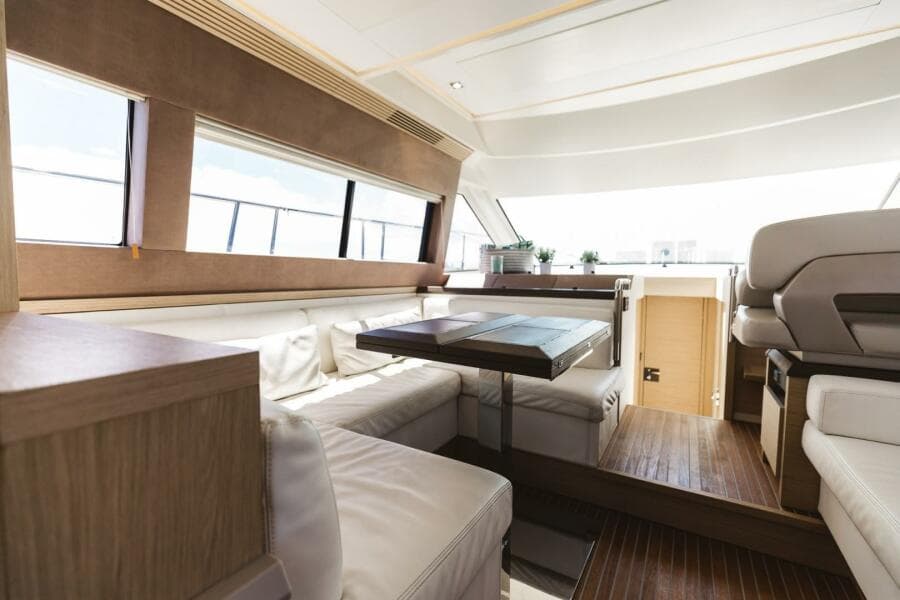 Luxurious interior of 2015 Beneteau Monte Carlo 5 yacht with elegant seating and wooden accents.