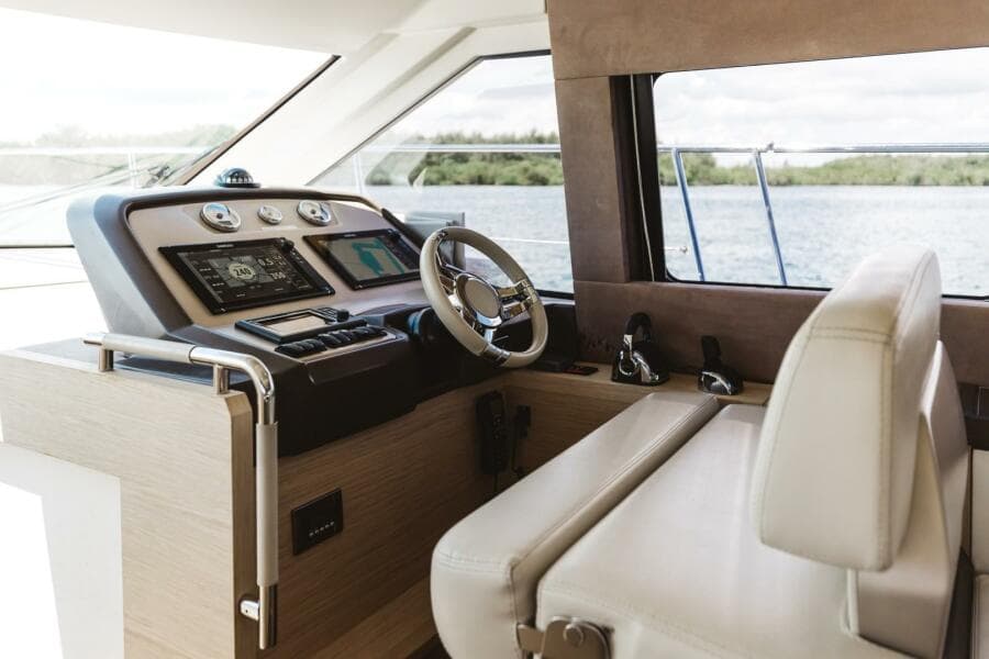 2015 Beneteau Monte Carlo 5 yacht helm with modern controls and scenic water view.