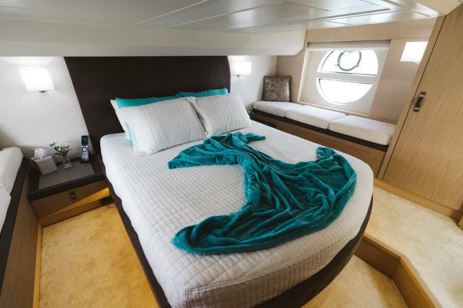 Luxurious bedroom in 2015 Beneteau Monte Carlo 5 yacht with elegant decor and natural light.