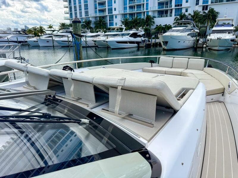 2023 Azimut Verve 47 yacht with luxurious deck seating in a marina setting.