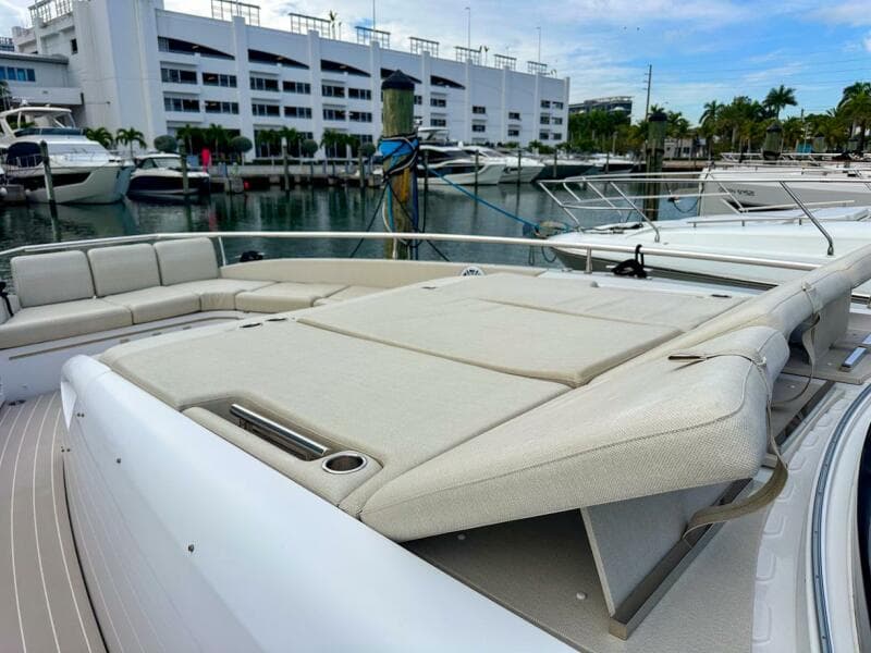 2023 Azimut Verve 47 luxury yacht with spacious deck seating in a marina setting.