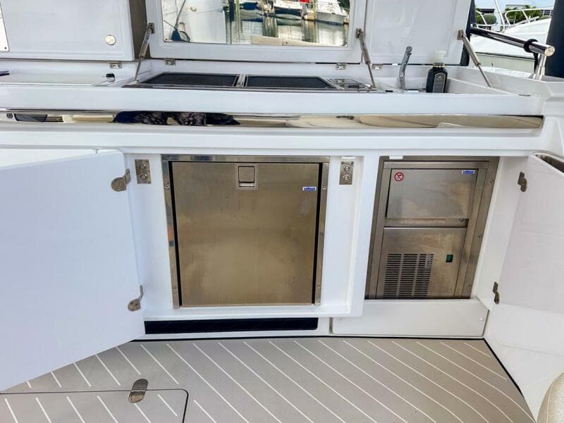 2023 Azimut Verve 47 yacht kitchen area with stainless steel appliances and sleek design.